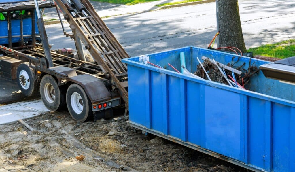 Blue dumpster filled with construction debris