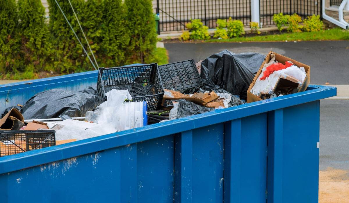Overflowing dumpster filled with debris.